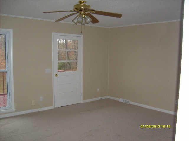 226 Busby Road Loretto, TN 38469 - Photo 8 of 16 an empty room with a window and a fan