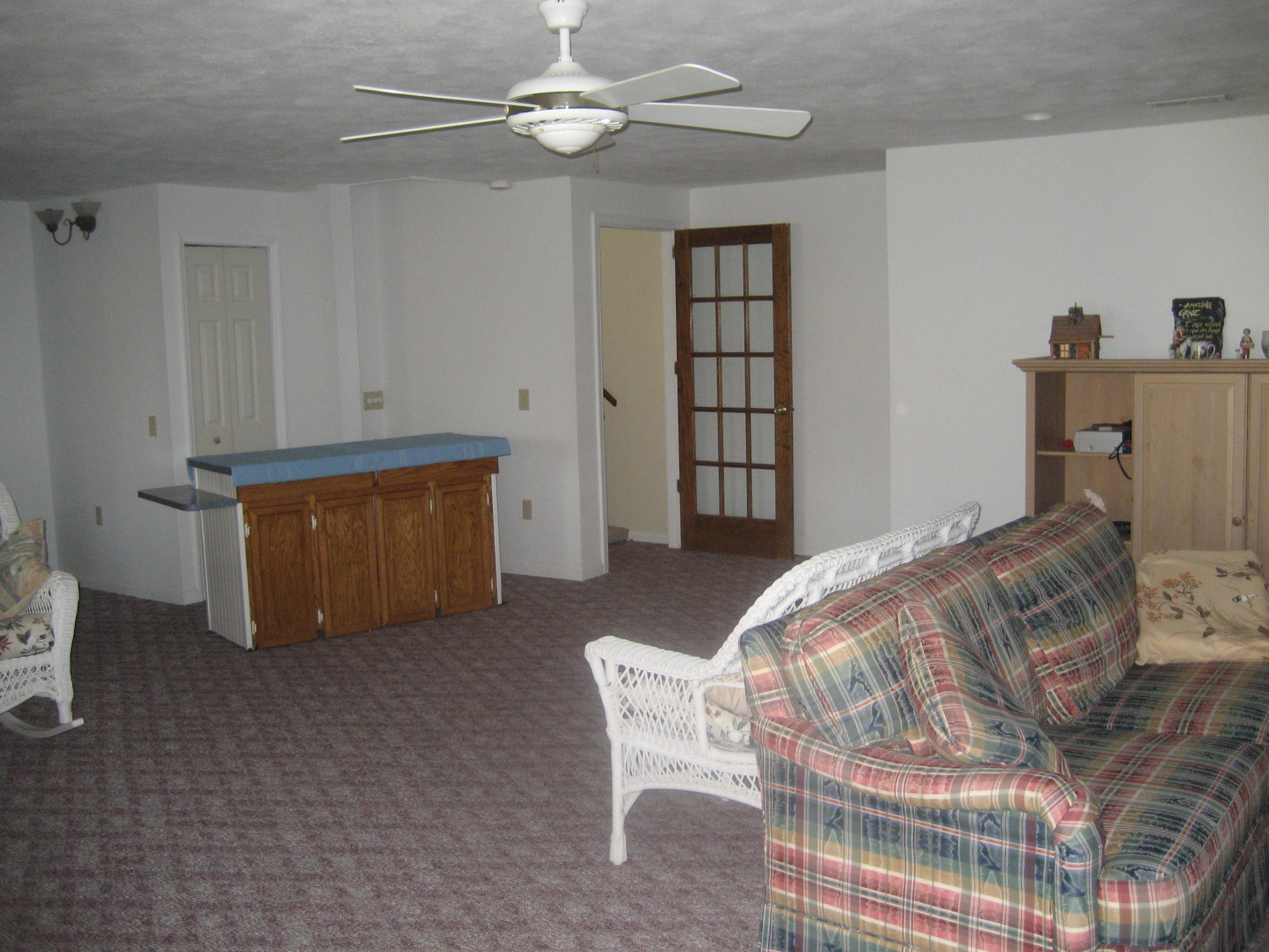 575 Highland Lake Road Union Hall, VA 24176 - Photo 16 of 18 a bedroom with a bed and a chandelier