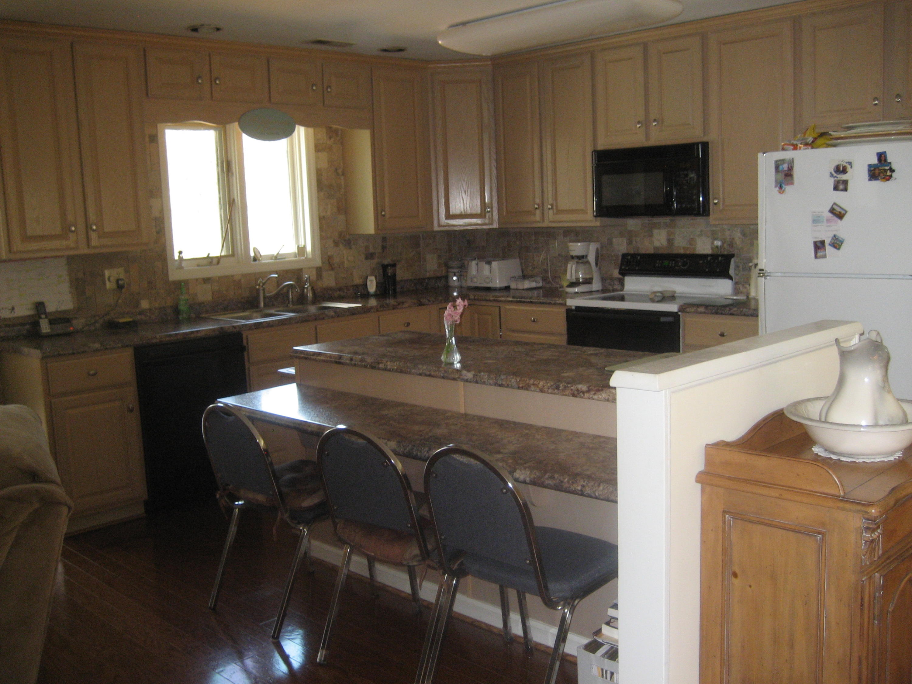 575 Highland Lake Road Union Hall, VA 24176 - Photo 8 of 18 a kitchen with stainless steel appliances granite countertop a stove a sink a microwave and a refrigerator