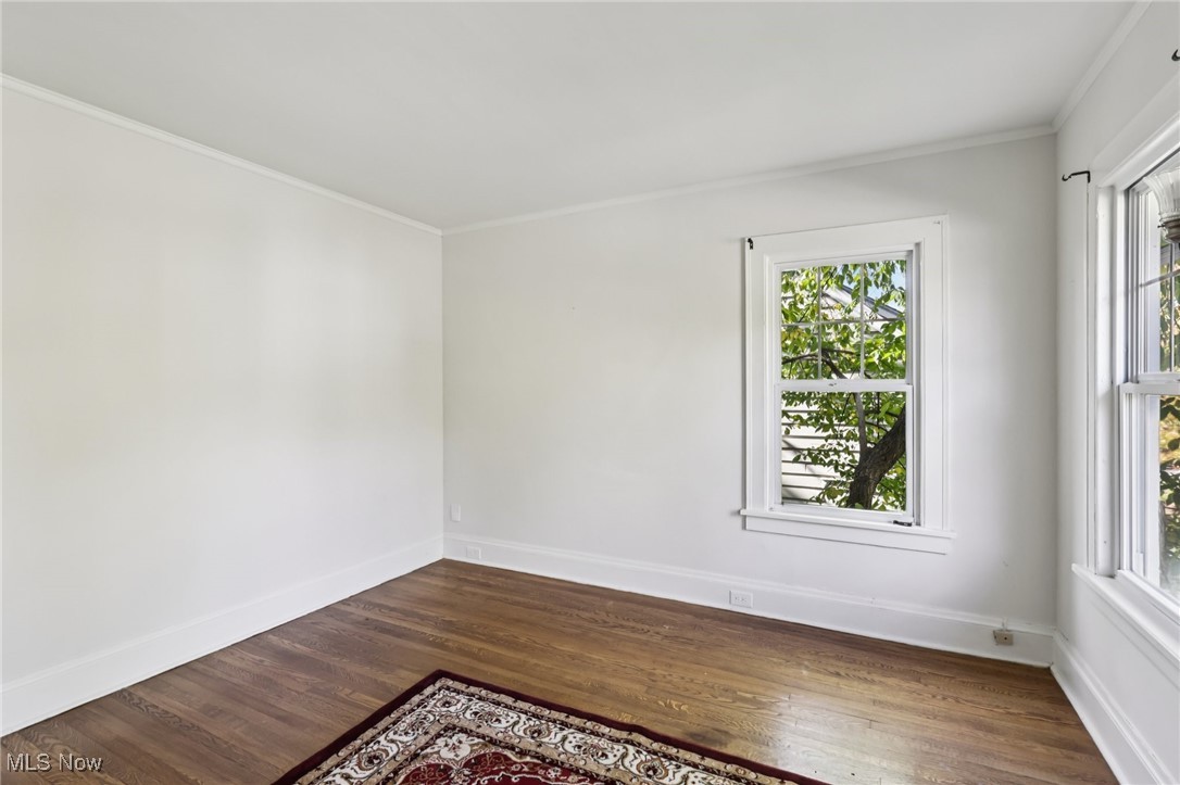 3054 East Overlook Road Cleveland, OH 44118 - Photo 29 of 50 Spare room featuring dark wood finished floors and crown molding
