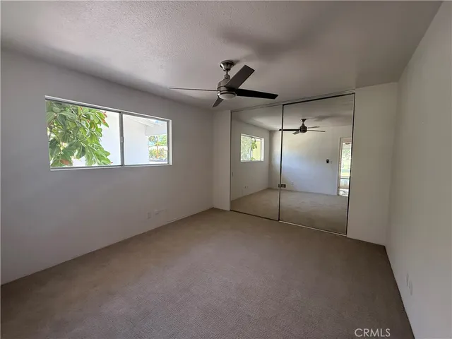 a view of room with window and ceiling fan