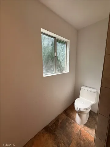 a white bath tub sitting next to a shower