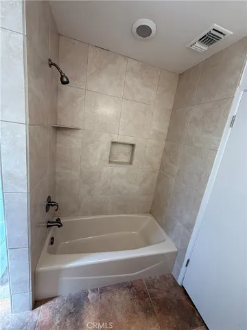 a view of a livingroom with a ceiling fan and window