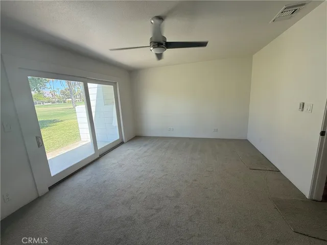 a view of a livingroom with a ceiling fan and window