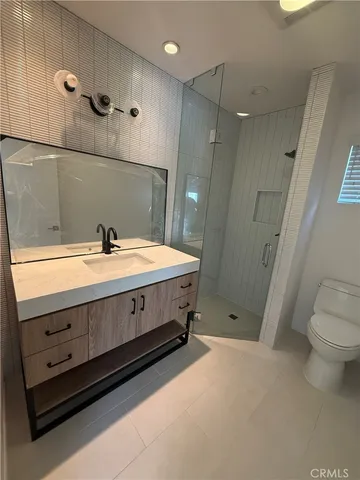a spacious bathroom with a double vanity sink toilet and a mirror