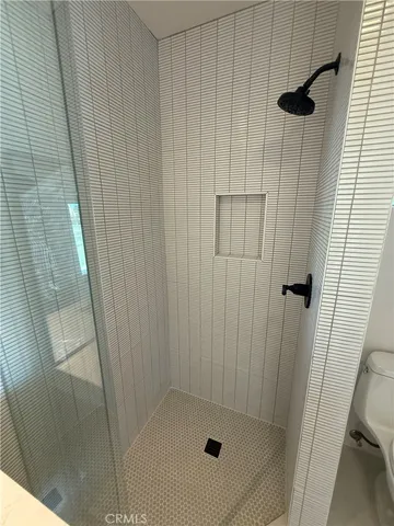 a bathroom with a toilet a sink and shower