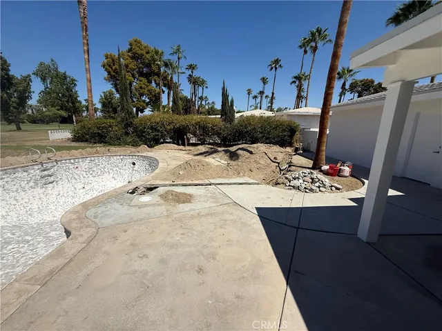 a view of a swimming pool with a yard