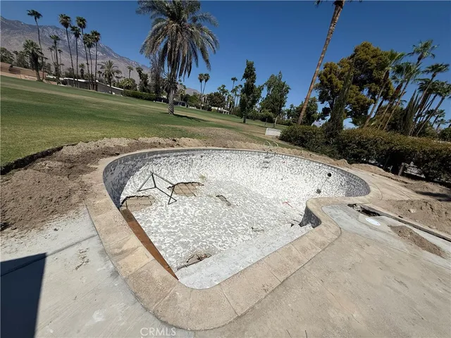 a view of a swimming pool and a yard