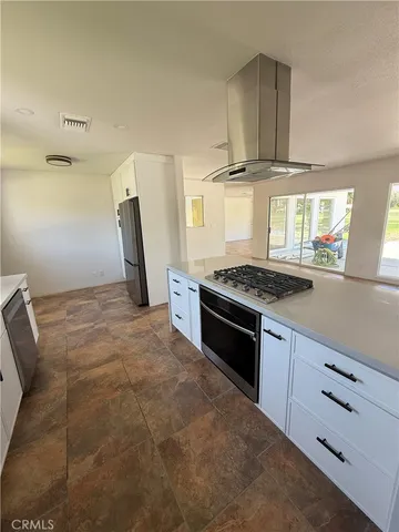a kitchen with stainless steel appliances a stove and a refrigerator