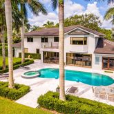 a view of a house with backyard and sitting area