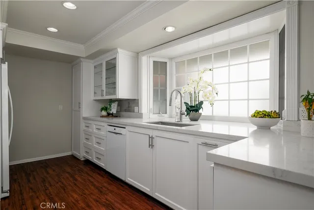 a bedroom with bed and a potted plant