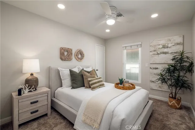 a bedroom with a large bed and a couch