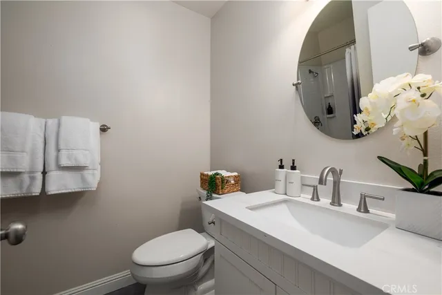 a bathroom with a sink toilet a mirror and shower