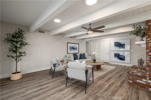 a balcony with wooden floor table and chairs