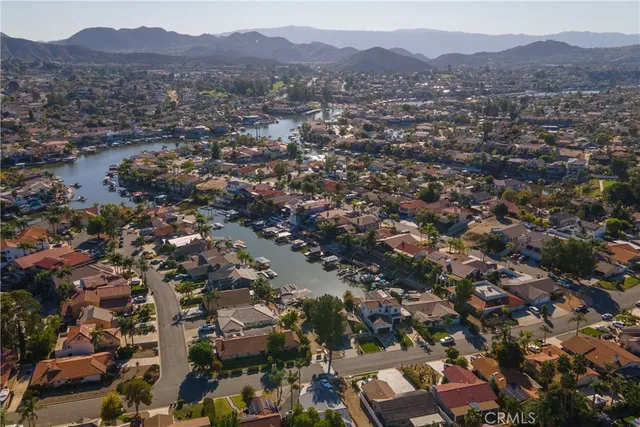 an aerial view of a house with a garden and lake view