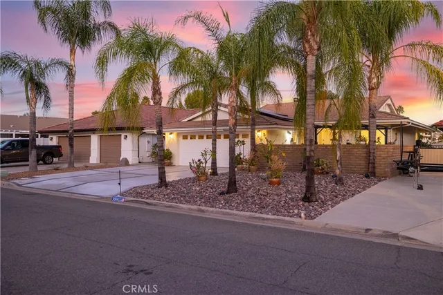 a patio with table and chairs and potted plants