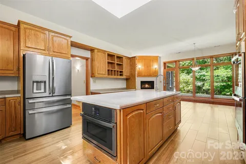 a kitchen with stainless steel appliances granite countertop a stove and a refrigerator