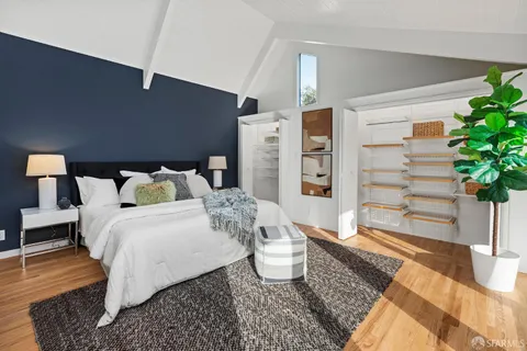 a bed room with a bed and a potted plant