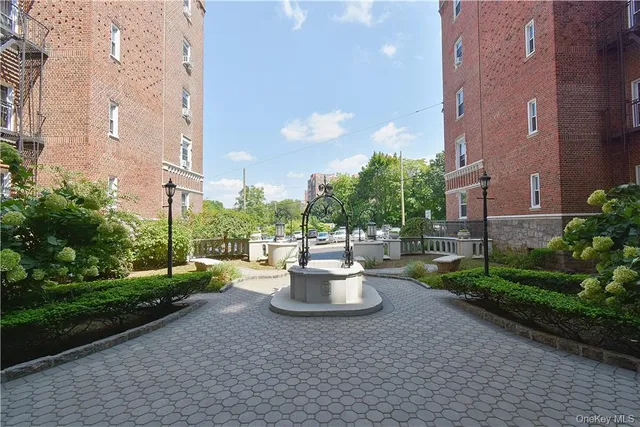 a view of a patio with a table and chairs and plants