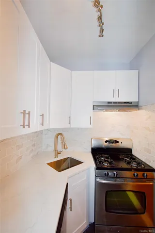 a white stove top oven sitting inside of a kitchen