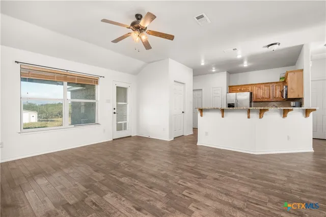 a kitchen with stainless steel appliances a stove a sink and white cabinets