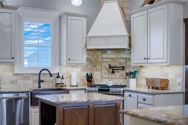 a view of a dining room with furniture a kitchen and chandelier