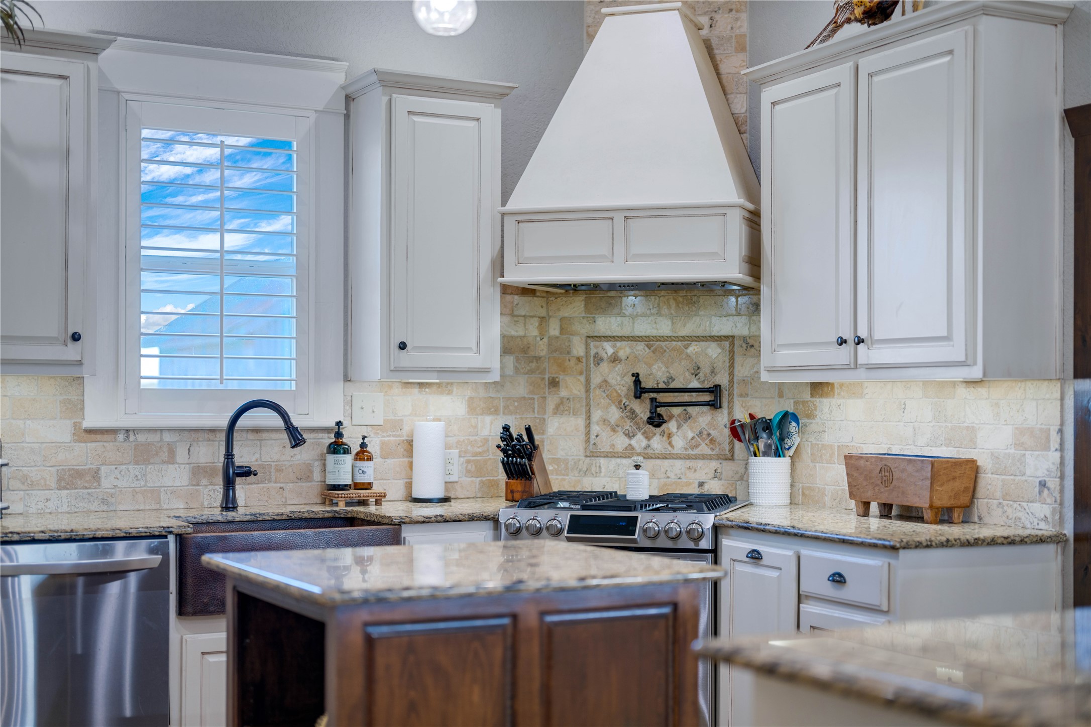 8323 East State Highway 29 Georgetown, TX 78626 - Photo 11 of 39 a kitchen with granite countertop a sink a stove and cabinets