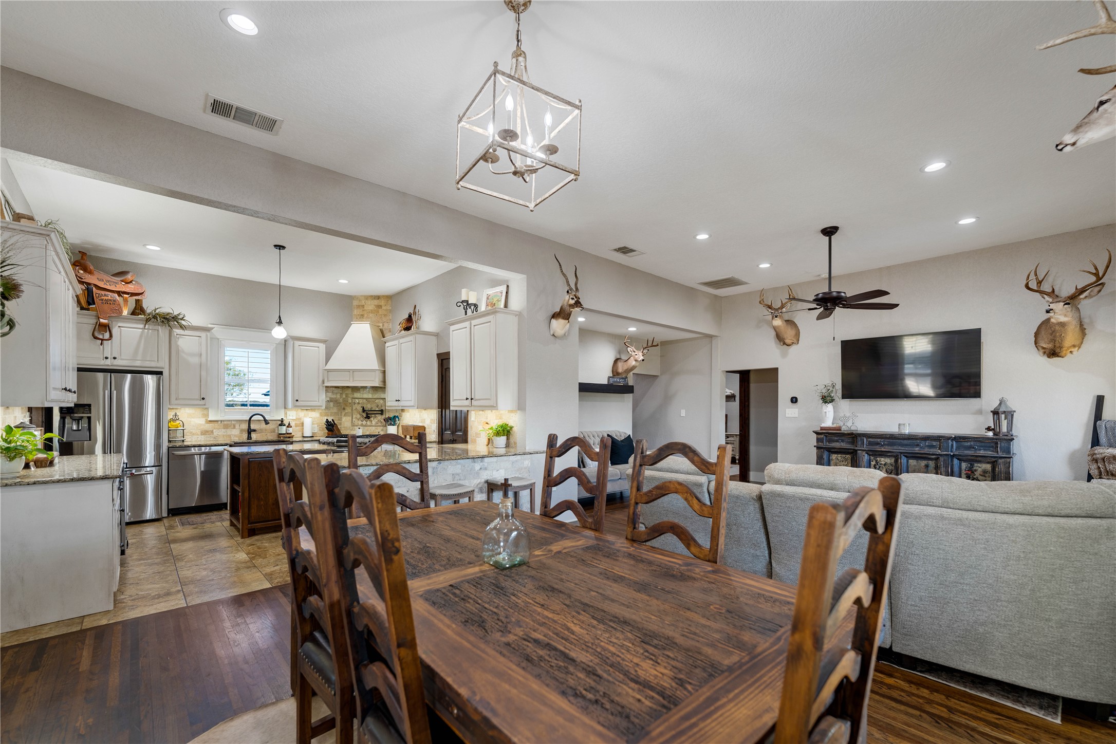 8323 East State Highway 29 Georgetown, TX 78626 - Photo 12 of 39 a view of a dining room with furniture a kitchen and chandelier