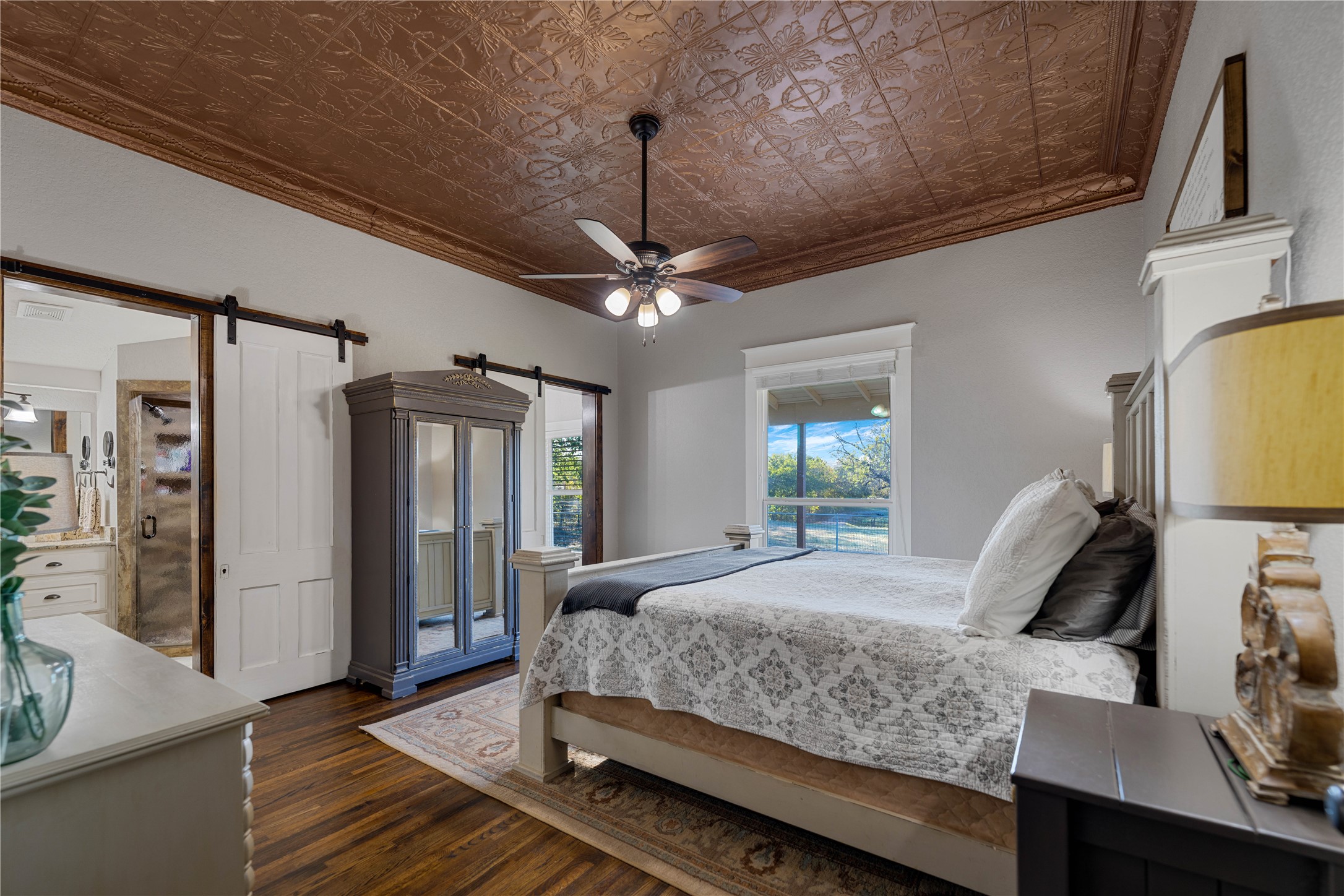 8323 East State Highway 29 Georgetown, TX 78626 - Photo 18 of 39 a bedroom with a bed a ceiling fan and a dresser