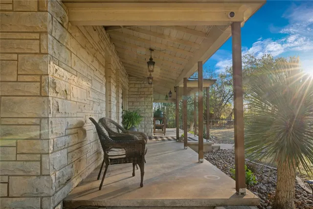 a kitchen with kitchen island granite countertop a sink a counter top space appliances and cabinets