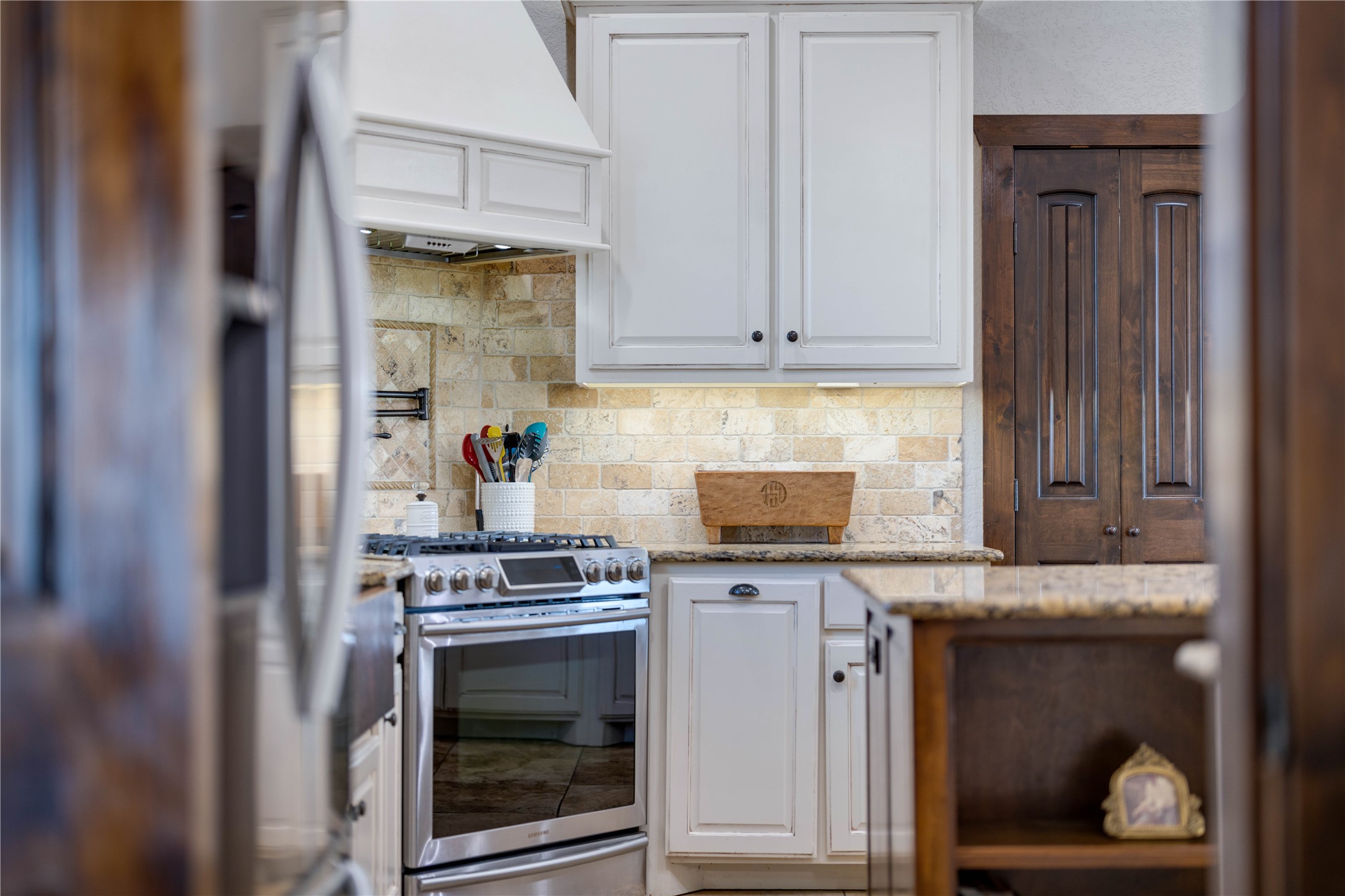 8323 East State Highway 29 Georgetown, TX 78626 - Photo 8 of 39 a kitchen with stainless steel appliances granite countertop a stove and a microwave