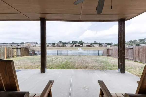 a view of a porch with a table and chairs