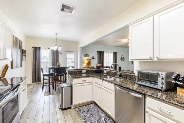 a kitchen with a sink stove cabinets and refrigerator
