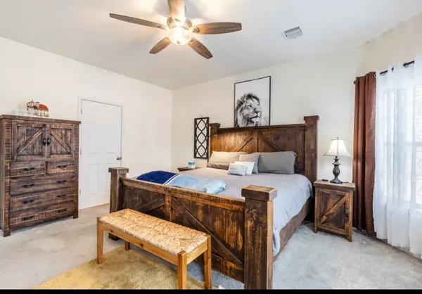 a bedroom with a bed and a chandelier