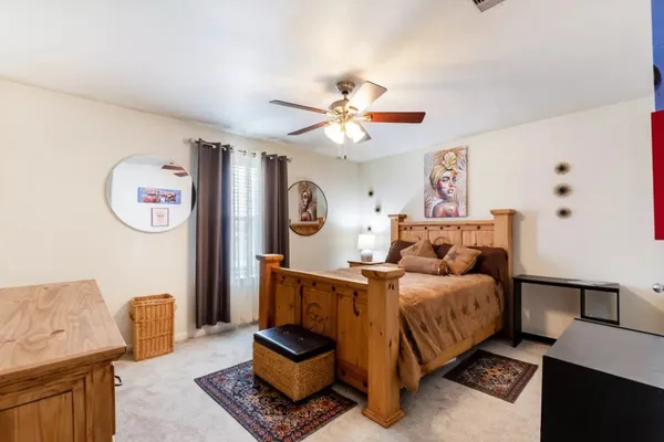 a bedroom with furniture and a chandelier