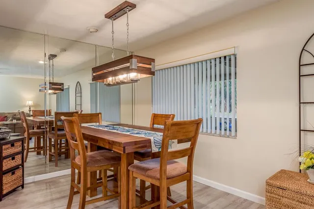 a dining room with a wooden table and chairs