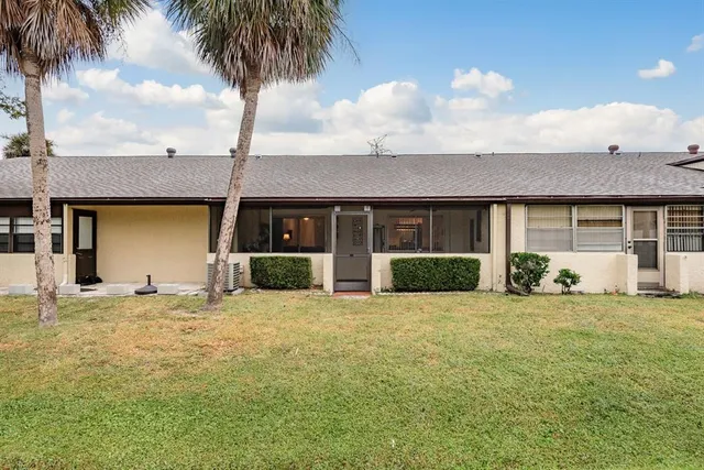 a front view of a house with a garden and shower