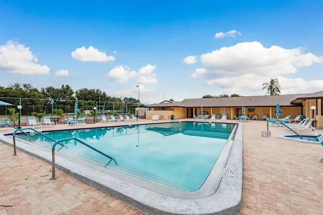 swimming pool view with a garden space