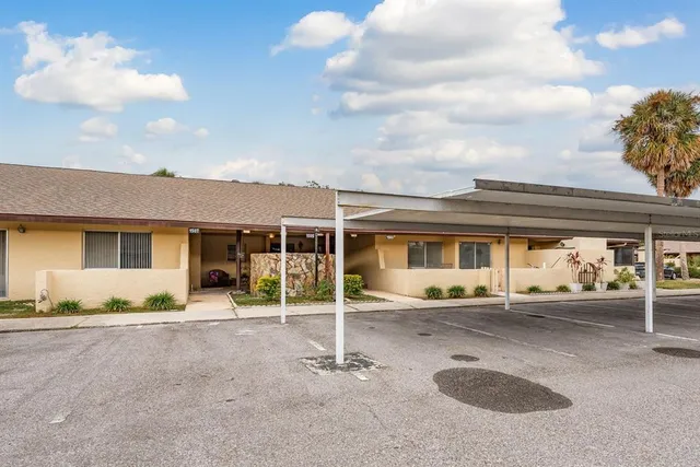 a backyard of a house with table and chairs