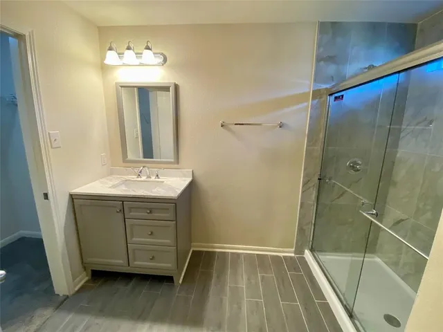 a bathroom with a sink a mirror and a shower