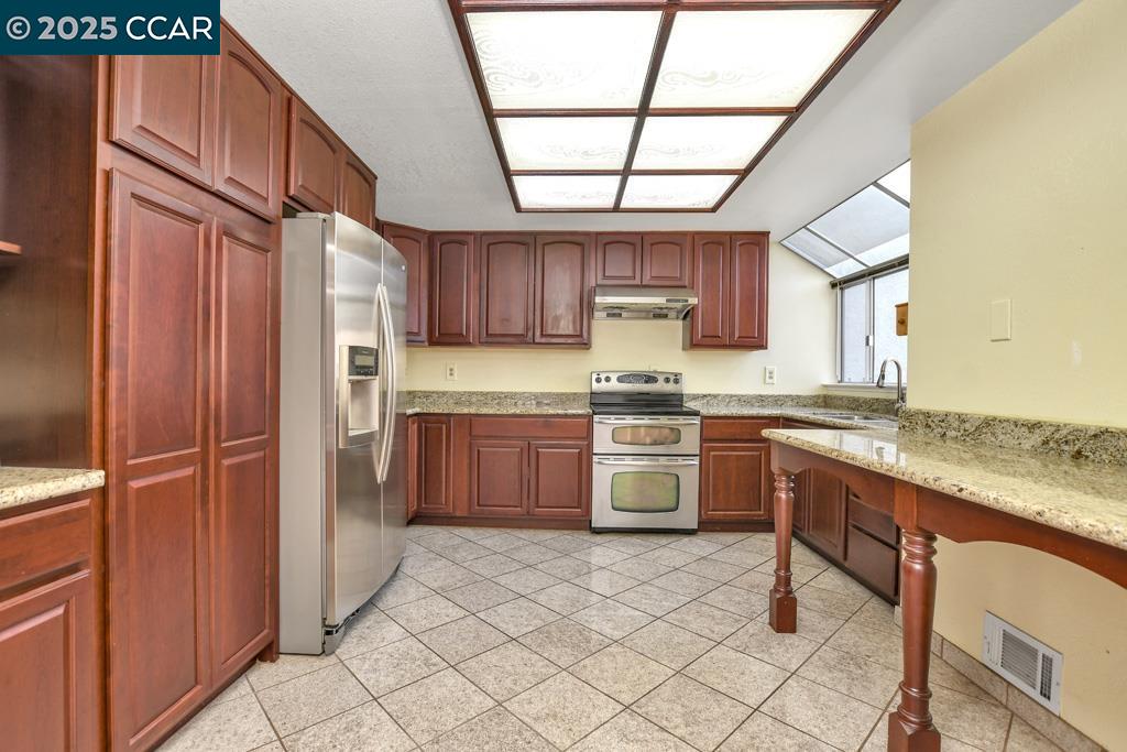 65 Edgewater Place Pittsburg, CA 94565 - Photo 12 of 31 a kitchen with stainless steel appliances granite countertop a refrigerator and a stove
