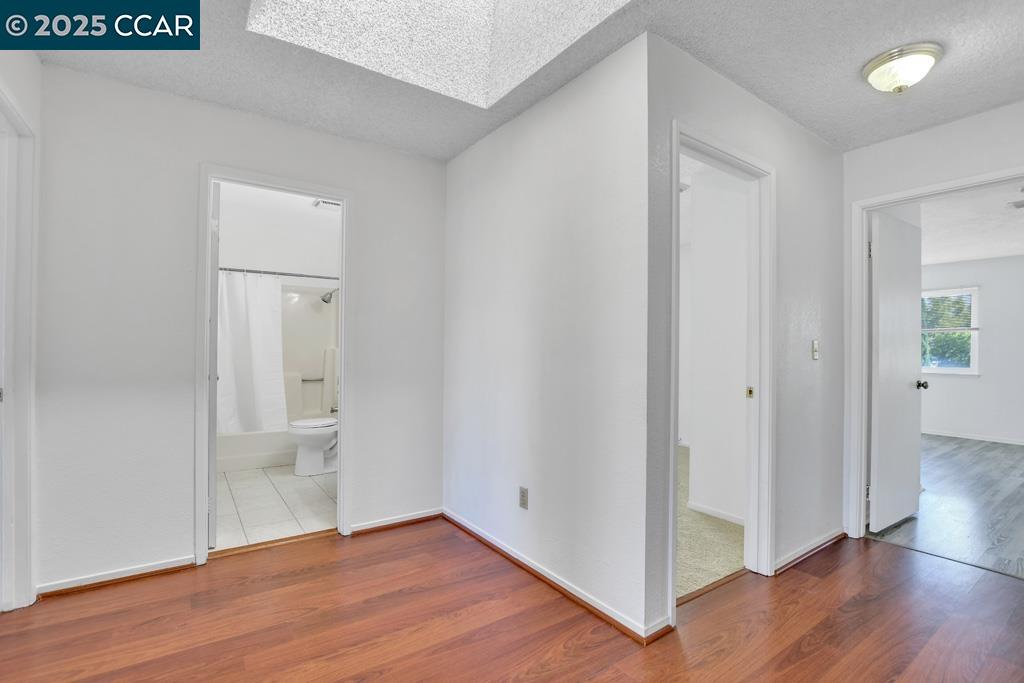 65 Edgewater Place Pittsburg, CA 94565 - Photo 16 of 31 a view of an empty room with wooden floor and a bathroom