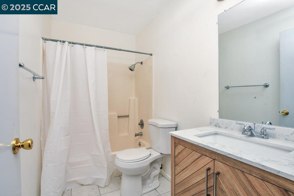 65 Edgewater Place Pittsburg, CA 94565 - Photo 21 of 31 a bathroom with a granite countertop sink toilet and shower