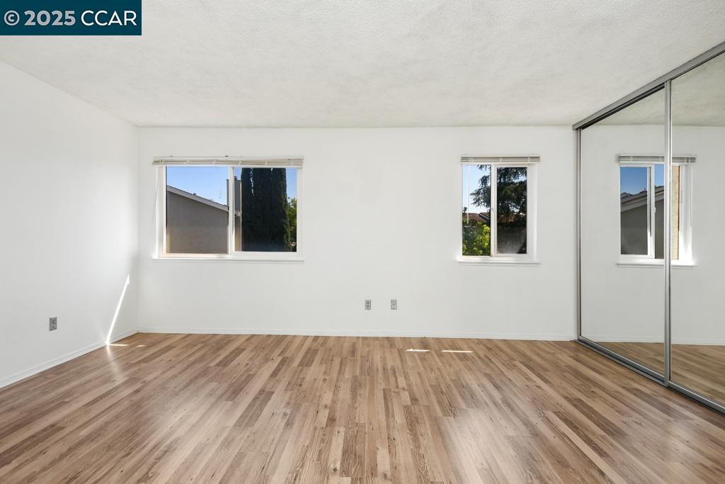 65 Edgewater Place Pittsburg, CA 94565 - Photo 24 of 31 a view of a room with wooden floor and more windows