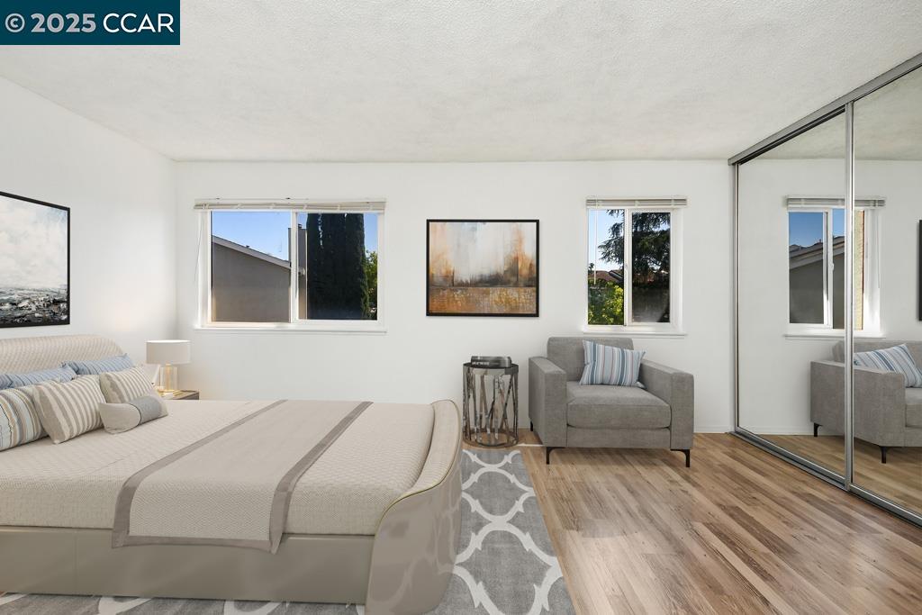 65 Edgewater Place Pittsburg, CA 94565 - Photo 25 of 31 a bedroom with a bed and a couch