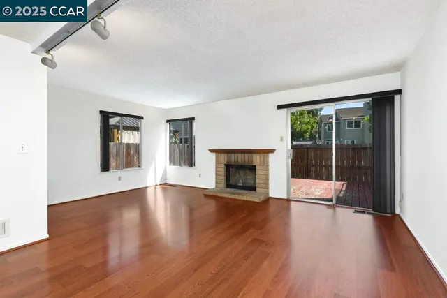 a living room with furniture a large window and a fireplace