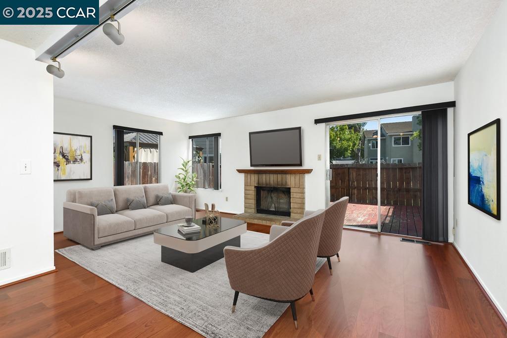 65 Edgewater Place Pittsburg, CA 94565 - Photo 10 of 31 a living room with furniture a large window and a fireplace