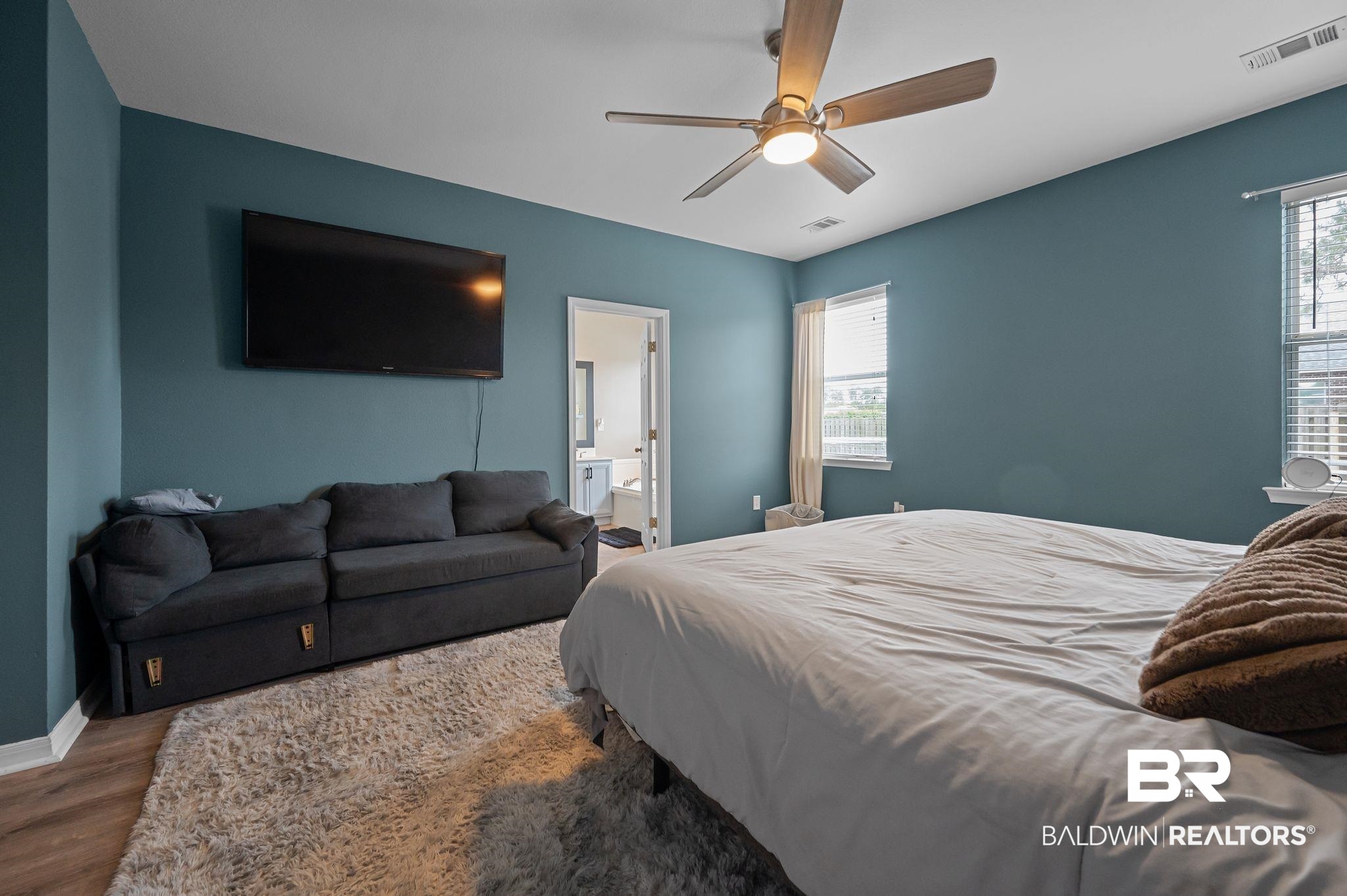 1287 Pembroke Way Foley, AL 36535 - Photo 21 of 39 Bedroom with wood finished floors, ensuite bath, and a ceiling fan