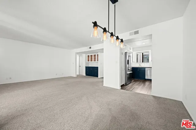 a view of a big room with closet and windows