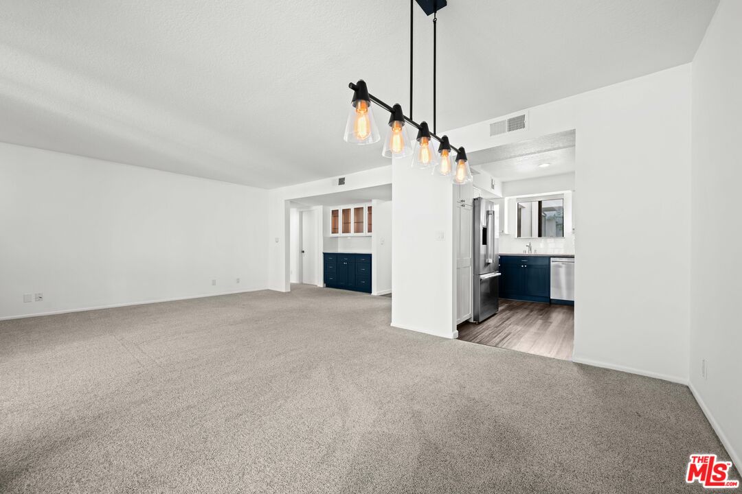 1312 South Saltair Avenue, Unit 215 Los Angeles, CA 90025 - Photo 11 of 31 a view of a big room with closet and windows